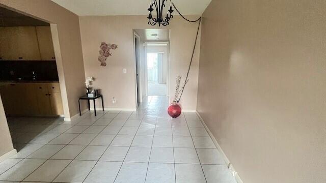 interior space featuring a chandelier, sink, and light tile patterned floors