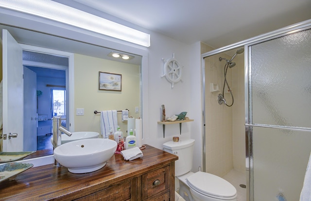363 Wellington J, West Palm Beach, FL 33417 - bathroom with toilet, sink, and a shower with shower door