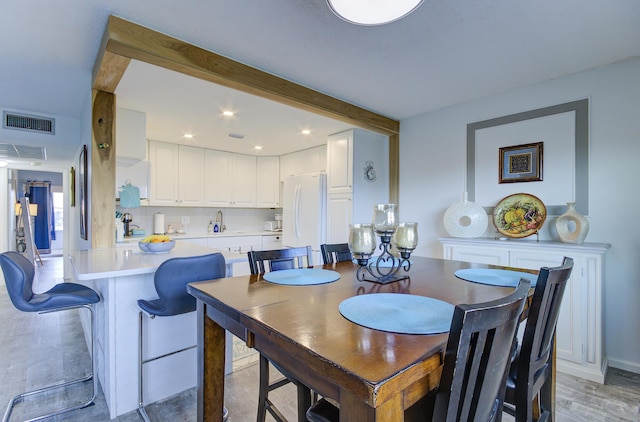 363 Wellington J, West Palm Beach, FL 33417 - dining space featuring beam ceiling and light hardwood / wood-style floors