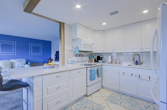363 Wellington J, West Palm Beach, FL 33417 - kitchen featuring sink, white appliances, white cabinets, a kitchen bar, and kitchen peninsula