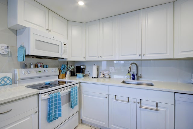 363 Wellington J, West Palm Beach, FL 33417 - kitchen with white appliances, sink, and white cabinets
