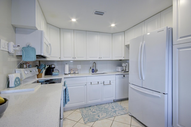 363 Wellington J, West Palm Beach, FL 33417 - kitchen with white appliances, sink, and white cabinets