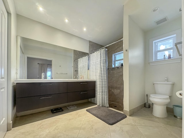 bathroom featuring vanity, toilet, and walk in shower