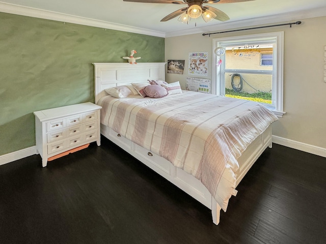 bedroom with dark hardwood / wood-style flooring, crown molding, and ceiling fan