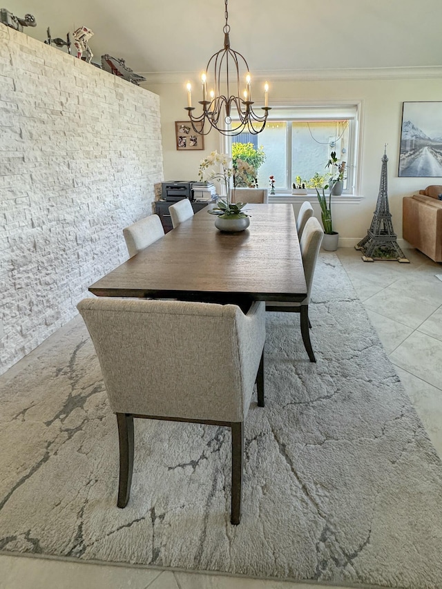 dining space with ornamental molding and a chandelier