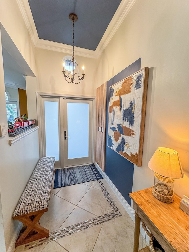 entryway with ornamental molding and a notable chandelier