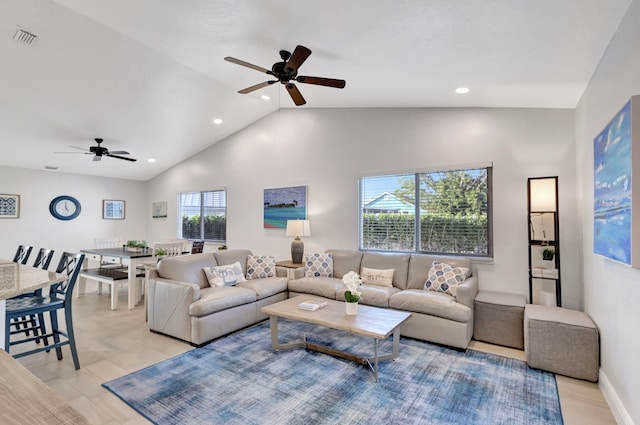 living room with ceiling fan and high vaulted ceiling