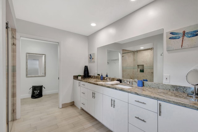 bathroom featuring vanity, hardwood / wood-style floors, and walk in shower