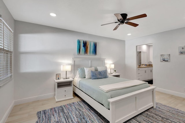 bedroom with ceiling fan, light hardwood / wood-style floors, and ensuite bath