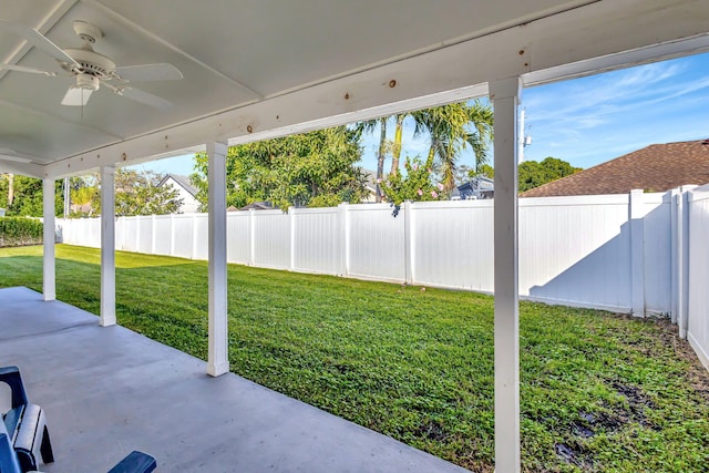 view of yard with ceiling fan and a patio area