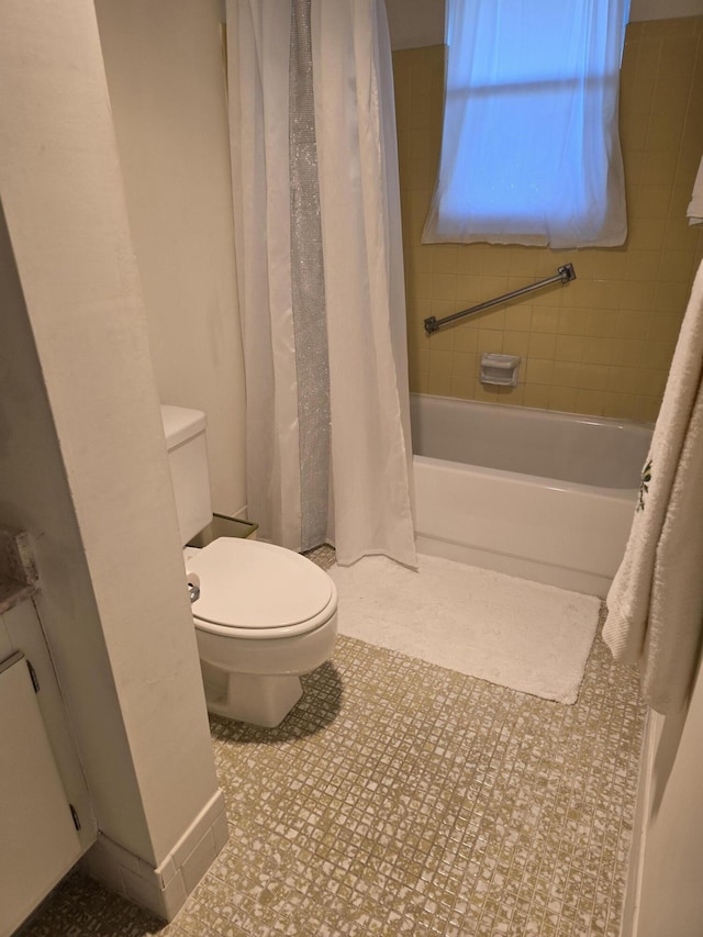 bathroom featuring shower / bath combo, tile patterned floors, and toilet