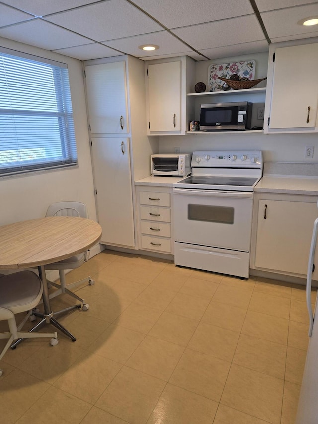 kitchen featuring white cabinetry, white electric stove, and a drop ceiling