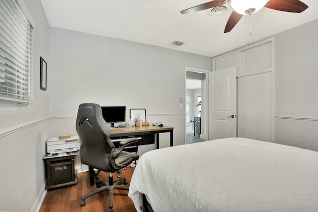 bedroom featuring ceiling fan and dark hardwood / wood-style flooring