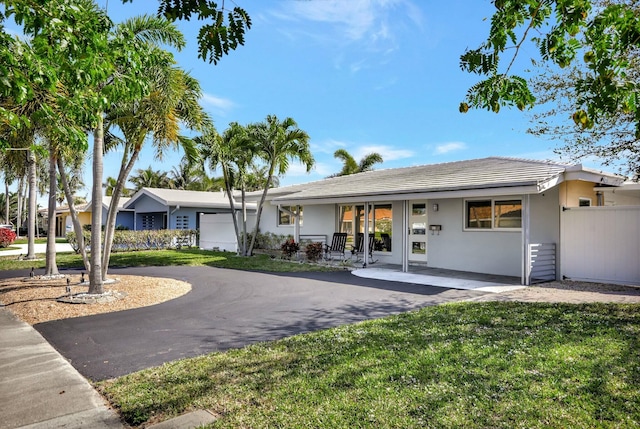 single story home featuring a front lawn and covered porch