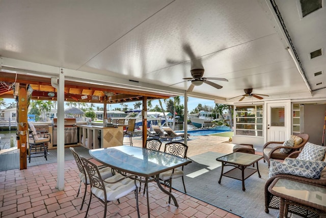 view of patio / terrace featuring a bar and ceiling fan