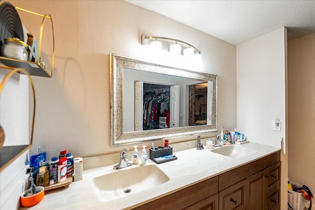 bathroom with vanity and a textured ceiling