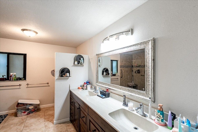 bathroom with vanity, tile patterned floors, a textured ceiling, and walk in shower