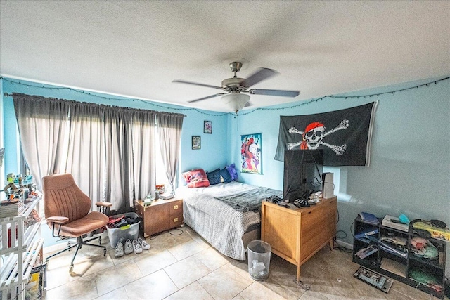 bedroom with ceiling fan and a textured ceiling