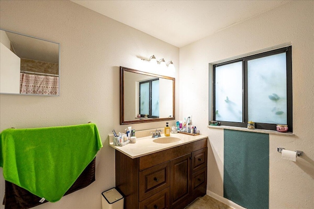 bathroom featuring vanity and curtained shower