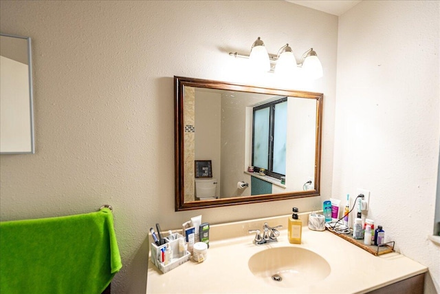 bathroom with vanity and toilet