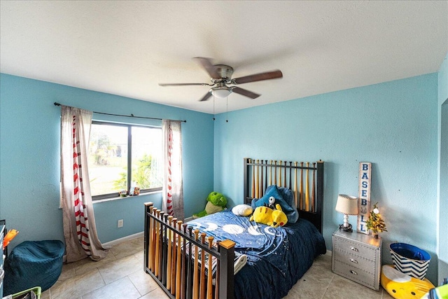 tiled bedroom featuring ceiling fan