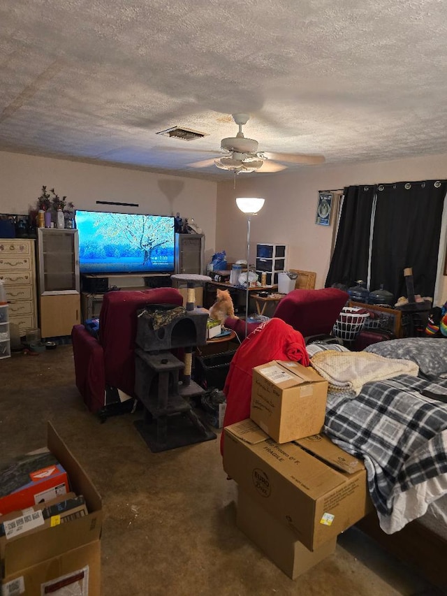 bedroom featuring ceiling fan, concrete floors, and a textured ceiling