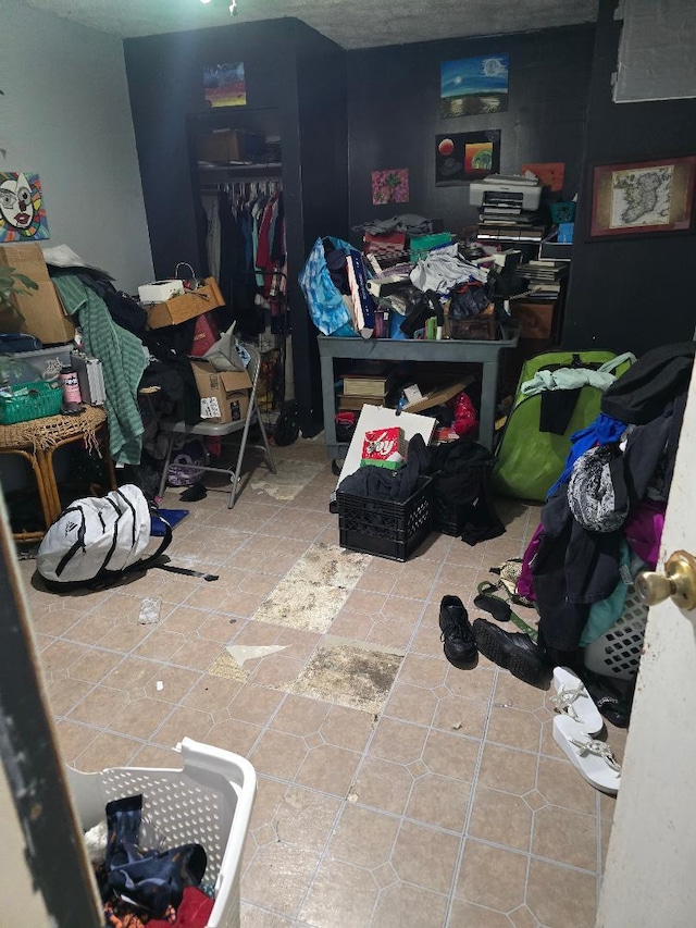 bedroom featuring tile patterned floors and a closet