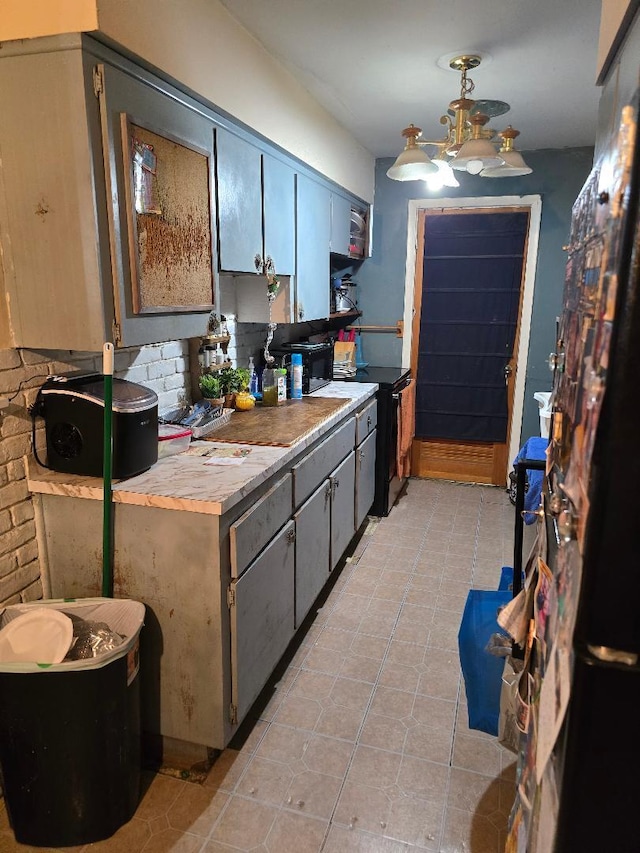 kitchen featuring butcher block counters, backsplash, and light tile patterned floors