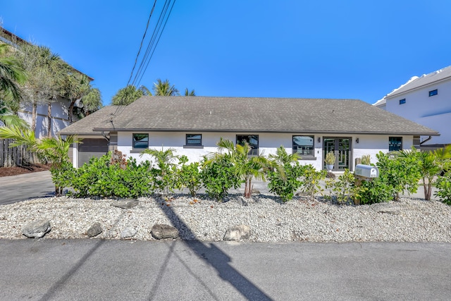 single story home with an attached garage, concrete driveway, and stucco siding