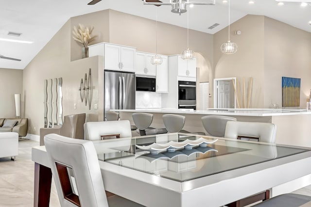 dining area featuring visible vents, high vaulted ceiling, and a ceiling fan