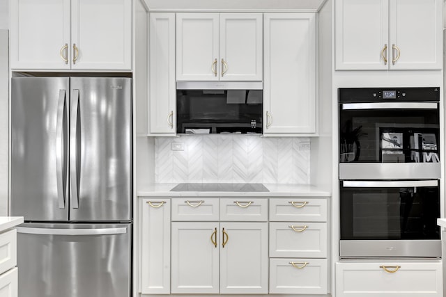 kitchen featuring stainless steel appliances, white cabinets, light countertops, and decorative backsplash