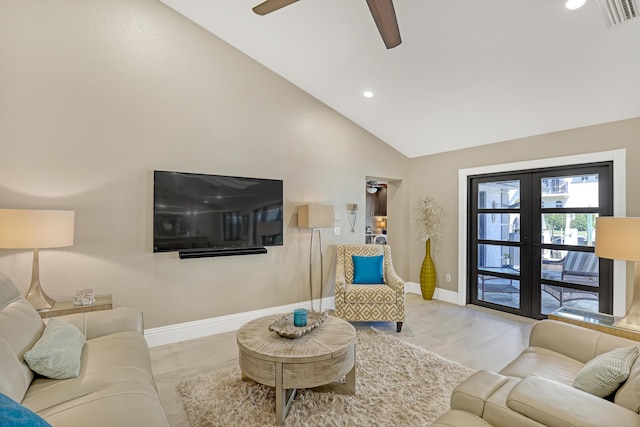 living area with lofted ceiling, french doors, visible vents, and baseboards