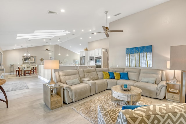 living room with high vaulted ceiling, a skylight, visible vents, and ceiling fan