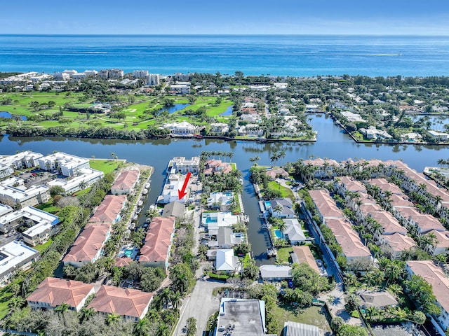 drone / aerial view with a water view and a residential view