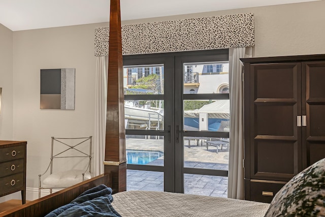 bedroom featuring access to outside, french doors, and stone finish flooring