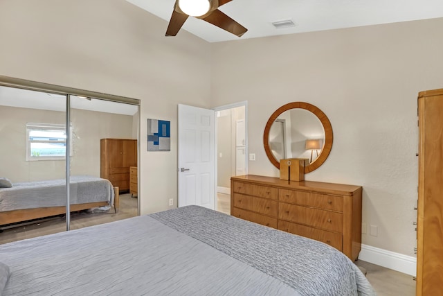 bedroom featuring high vaulted ceiling, a ceiling fan, visible vents, baseboards, and a closet