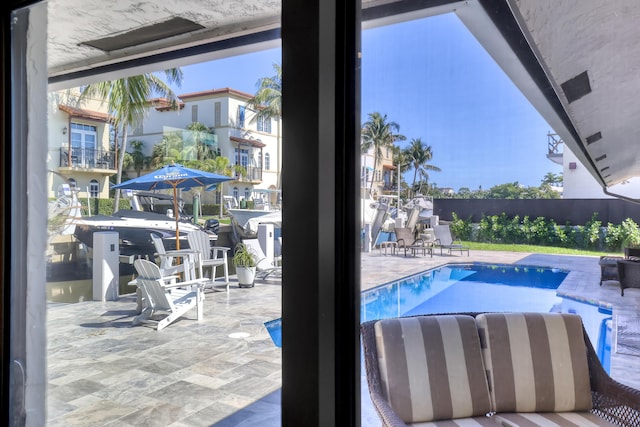 view of swimming pool featuring a fenced in pool, a patio, and fence