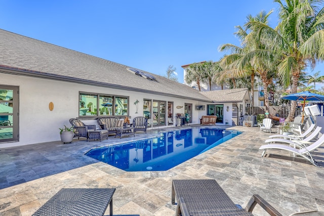 view of swimming pool with a fenced in pool, a patio area, fence, and an outdoor living space