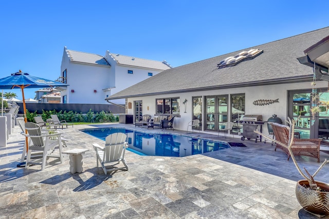 view of swimming pool with a patio area, fence, and a fenced in pool