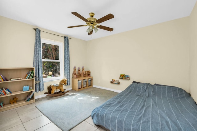 bedroom with ceiling fan and light tile patterned flooring