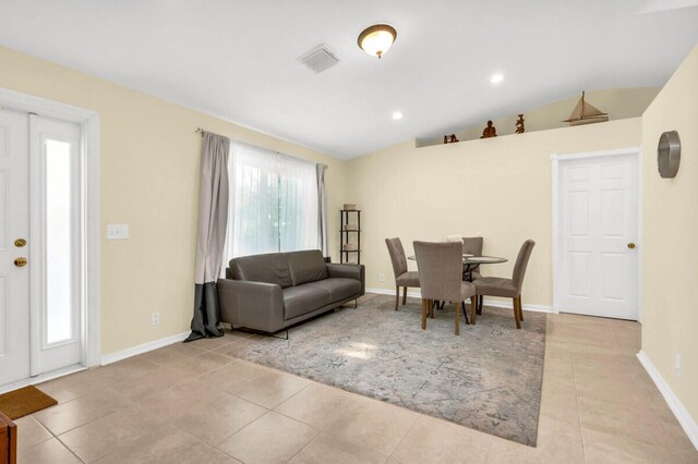 spare room with sink, light tile patterned floors, and high vaulted ceiling