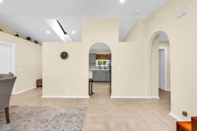 kitchen featuring gray cabinets, sink, light stone counters, and white dishwasher