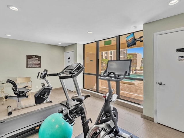 exercise room with recessed lighting, baseboards, and expansive windows