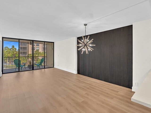 unfurnished dining area featuring light wood-type flooring and an inviting chandelier