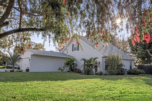 view of home's exterior featuring a garage and a lawn