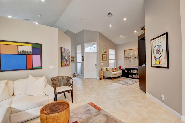 tiled living room featuring high vaulted ceiling