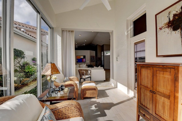 sunroom / solarium featuring vaulted ceiling