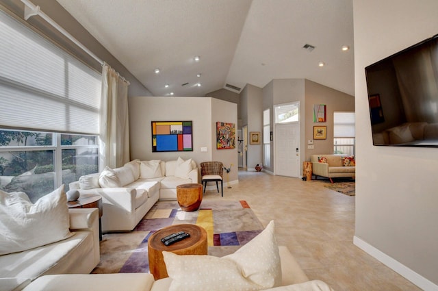 living room featuring lofted ceiling and a healthy amount of sunlight