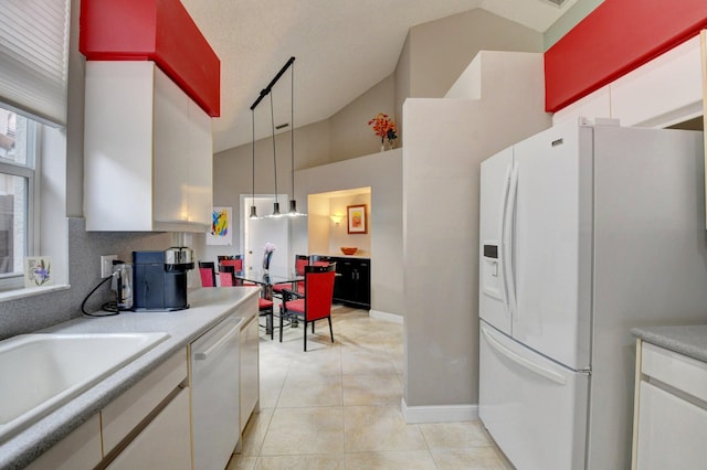 kitchen with white cabinetry, light tile patterned floors, white appliances, and pendant lighting