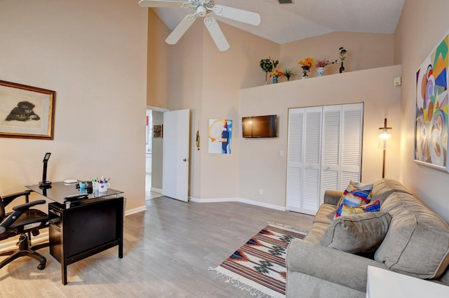 office space featuring wood-type flooring, high vaulted ceiling, and ceiling fan